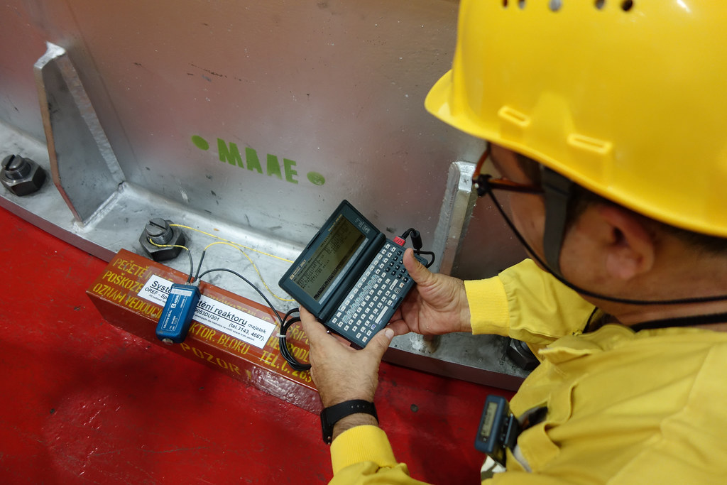 03210496 The IAEA inspector verifies that the seals on the… Flickr