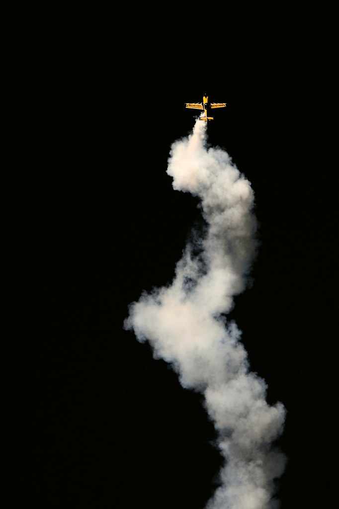 Corkscrew A tiny yellow stunt plane corkscrews skywards at… Flickr