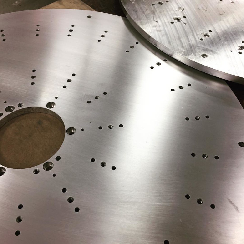 Large drilled discs make their way through multiple machin… Flickr