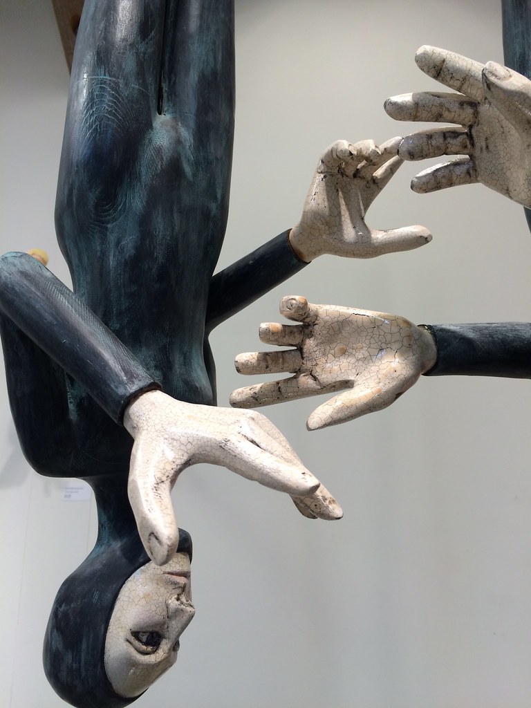 Hands A wood sculpture hanging from the high ceiling in a … Flickr