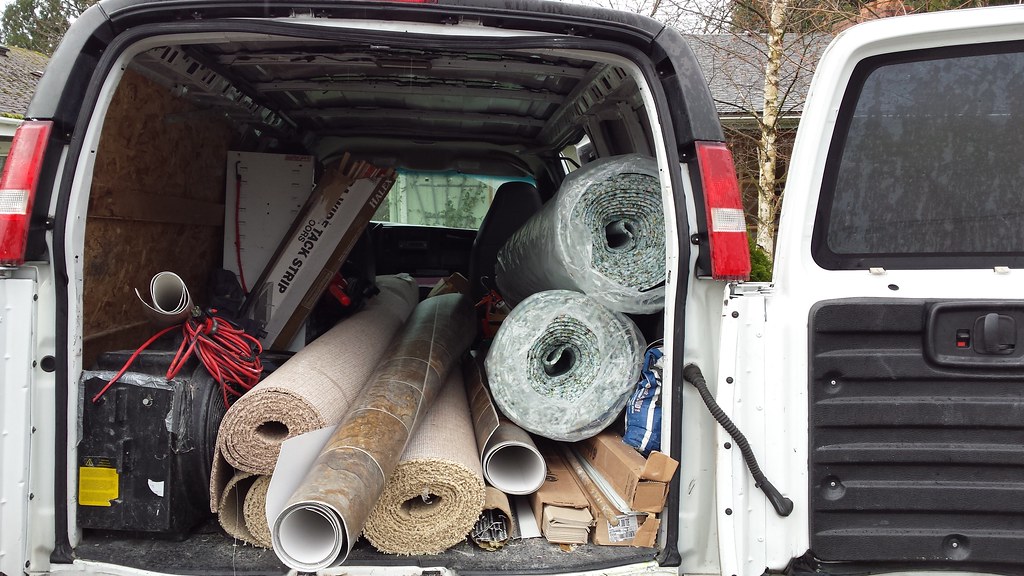 Carpet installer's truck with rolls of brown carpet and pa… Flickr