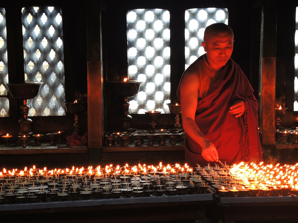 KathmanduMonk is lighting candles (Explored, 15/04/2015) Flickr