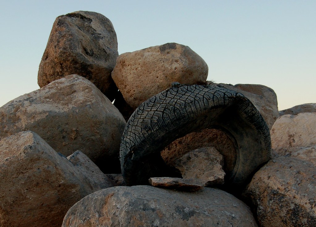 Old tire on a rock pile Vishal Majithia Flickr