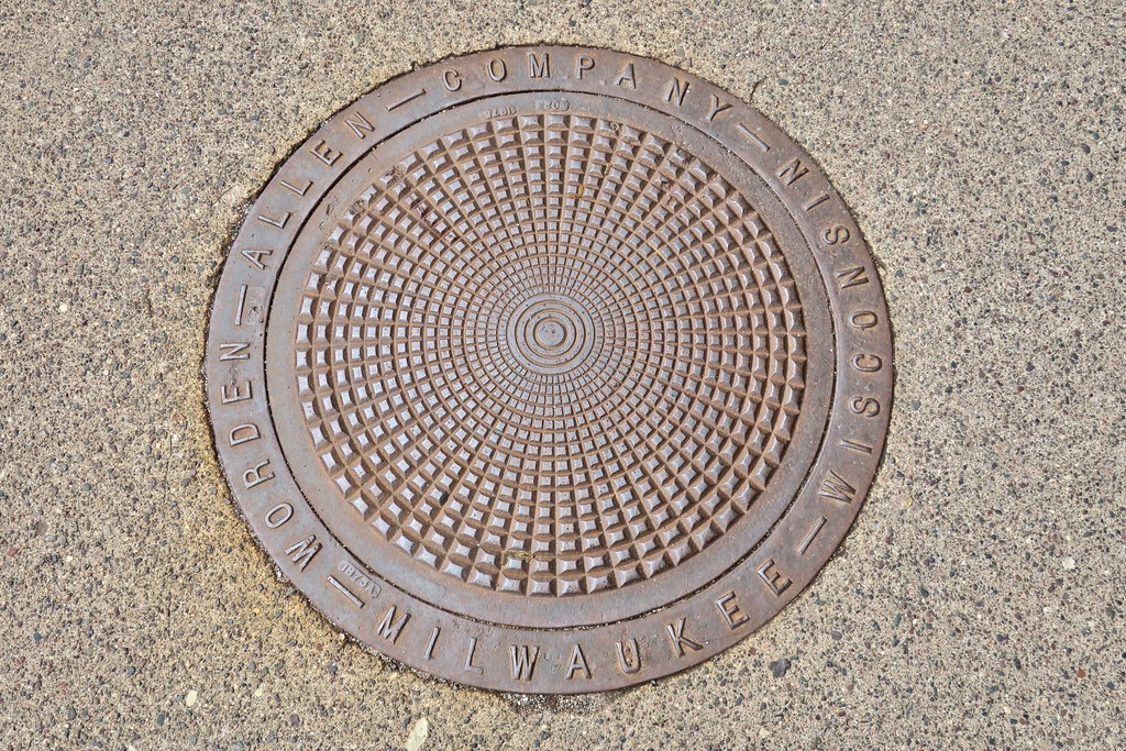 WordenAllen Company, Ironwood, MI Manhole cover in an Iro… Flickr