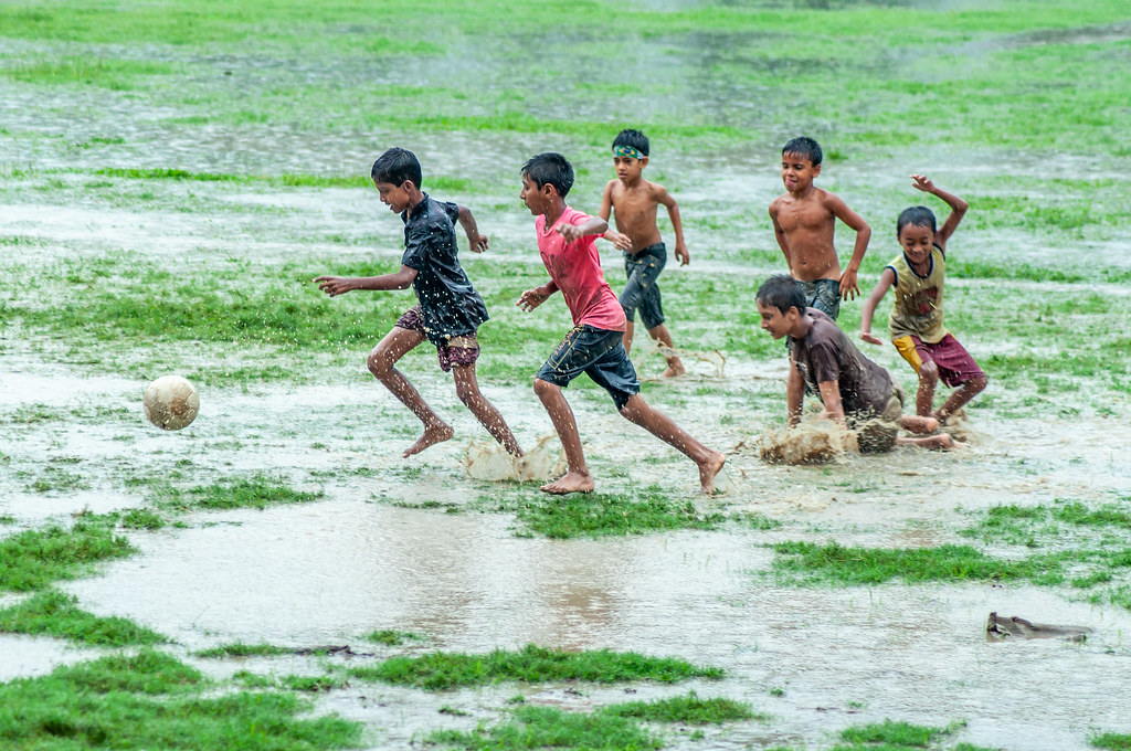 Kids Playing Soccer In The Rain