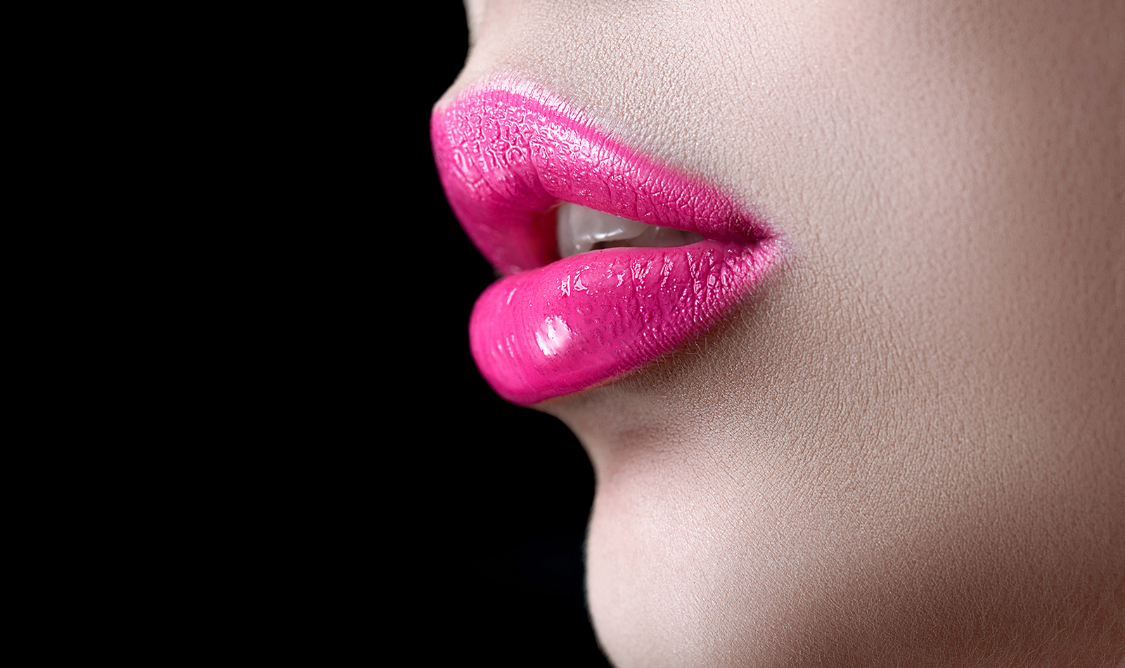 Closeup macro photo of pretty natural lips with pink glossy lips The