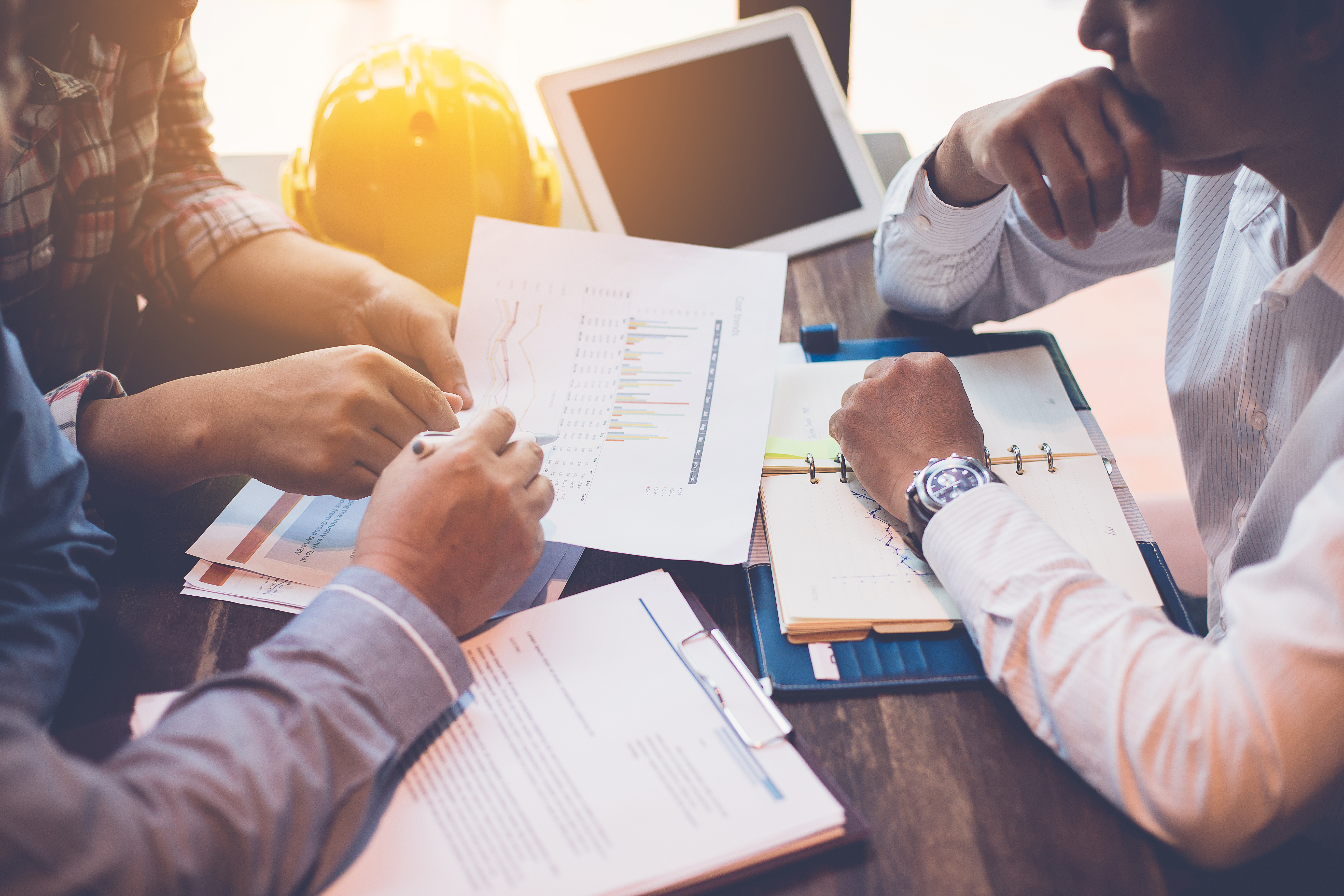 Three business people serious and working hard together in the office