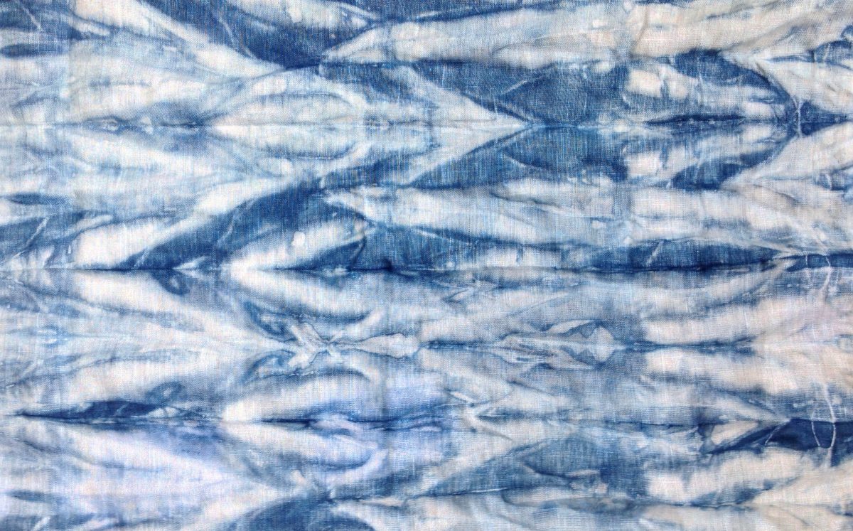 An Indigo dyed linen scarf with arashi shibori folding and pleating