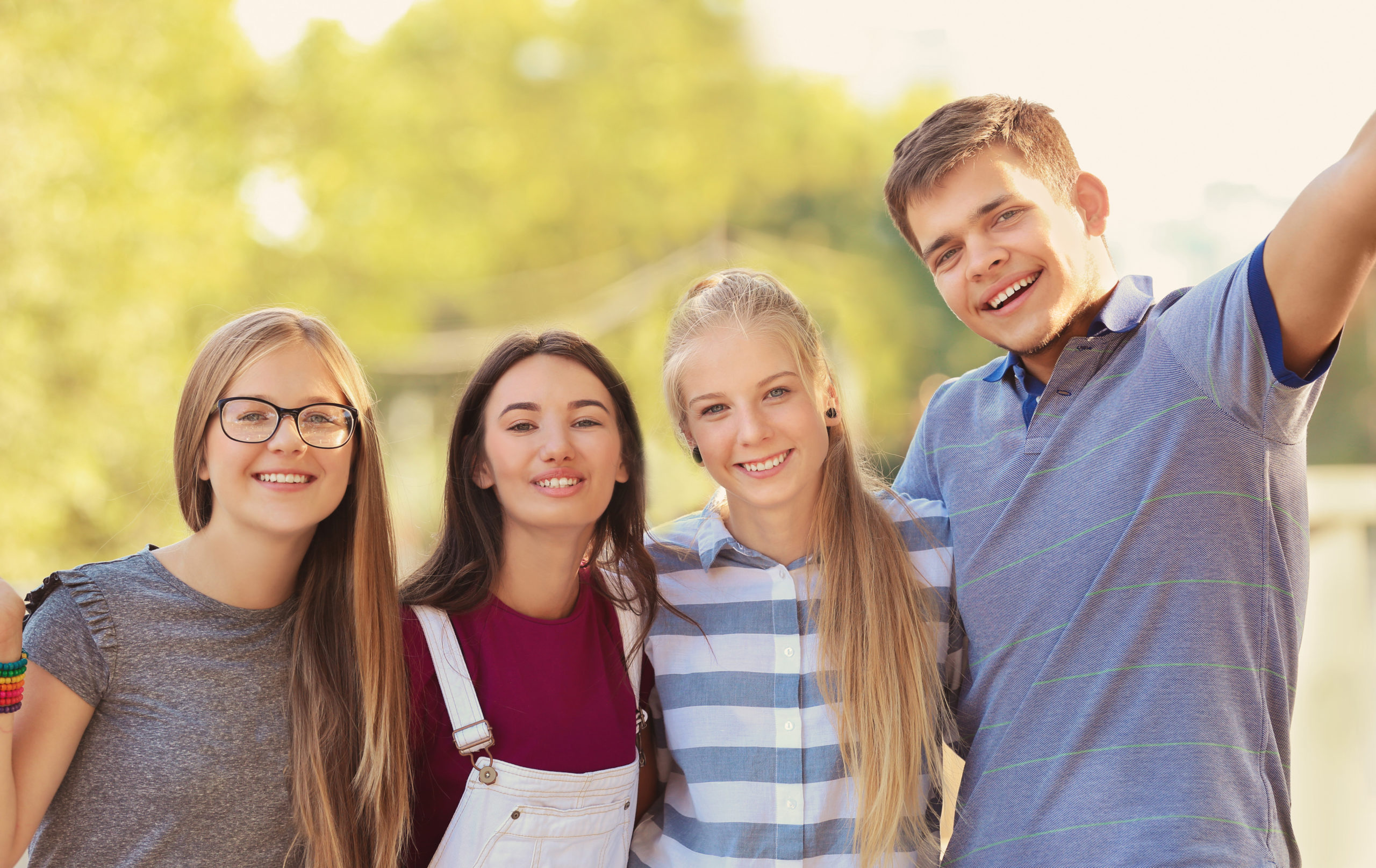 Happy teenagers posing on city street - Medical Associates of Northwest Arkansas