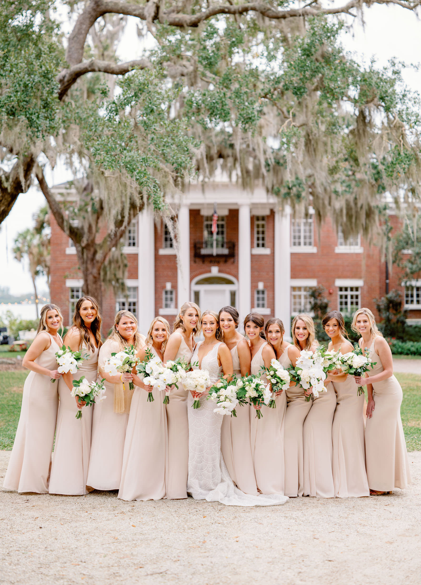 Elegant Bride in Jane Hil Beaded Luella Wedding Dress and Bridesmaids in Champagne Dresses