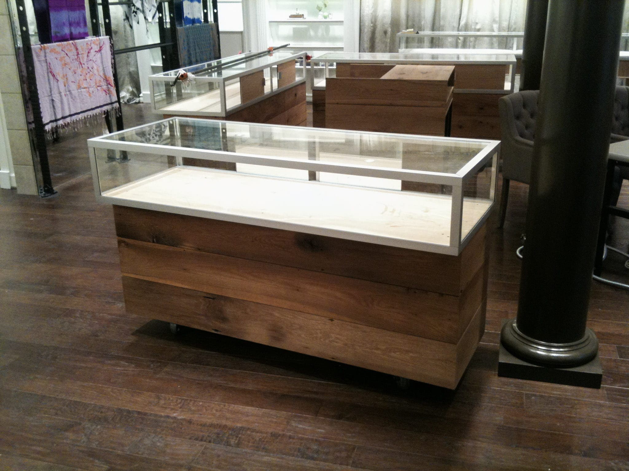 Reclaimed white oak and glass jewelry store display cases MDM Design