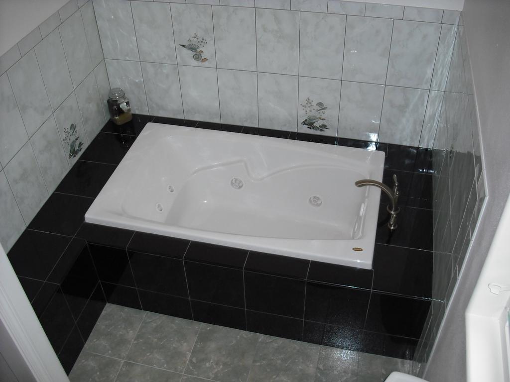 Jacuzzi Tub with Black Granite Tile from R.A.D. Builders LLC in Hilo