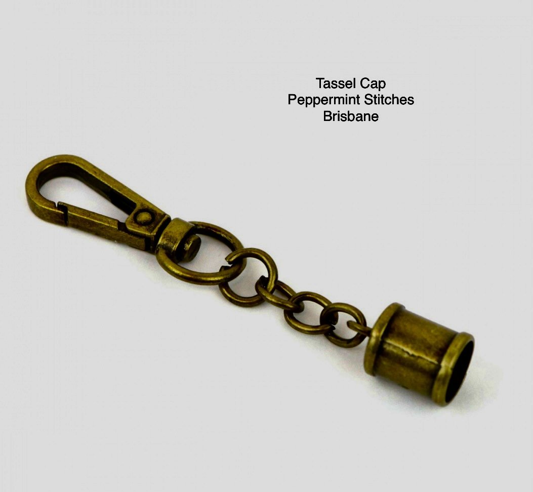 Two Tassel Caps with Swivel Antique From Sallie Tomato 026404944238