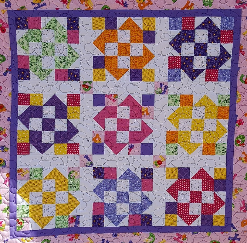 Completed quilts on my longarm.