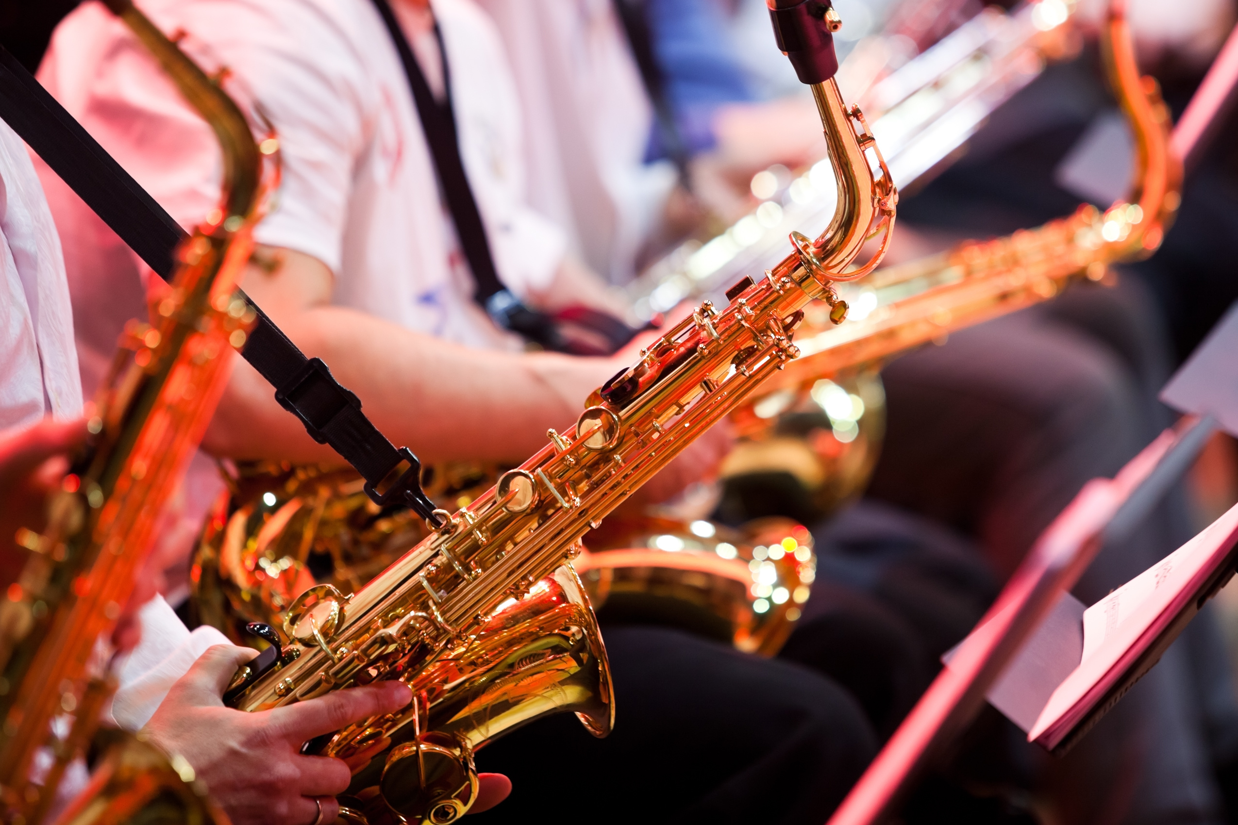 Saxophone in the hands of a musician in an orchestra closeup MercatorJazz
