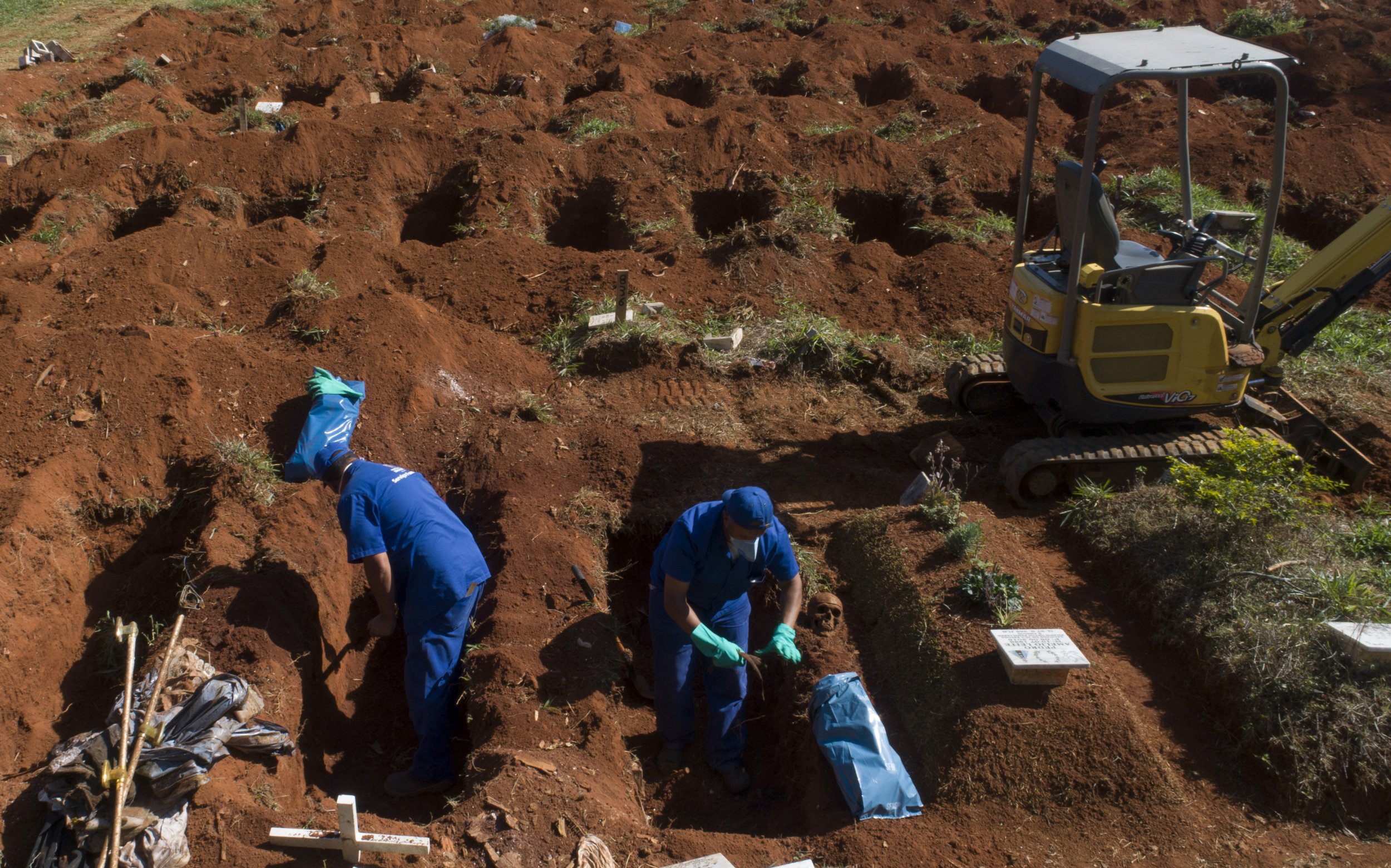 A cemetery worker exhumes the body of a person buried three years ago