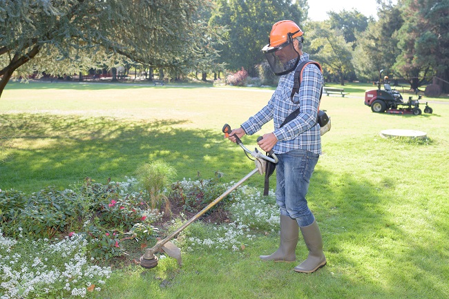 garden worker doing his job Metro Lawn Care, Inc.