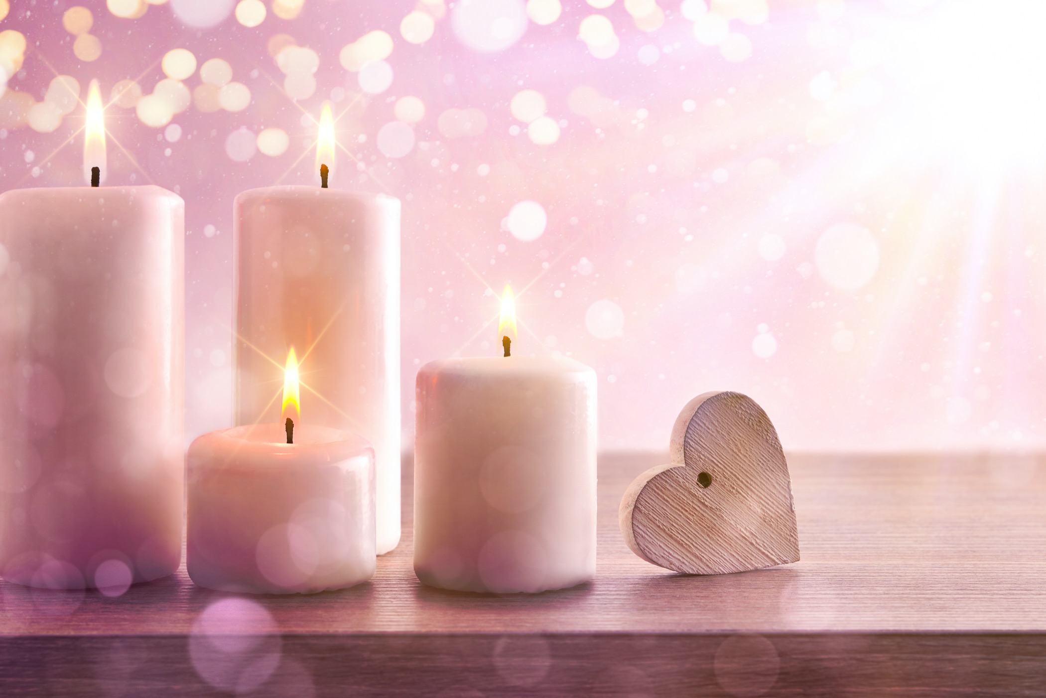 Candles with pink dreamy background with heart and lights