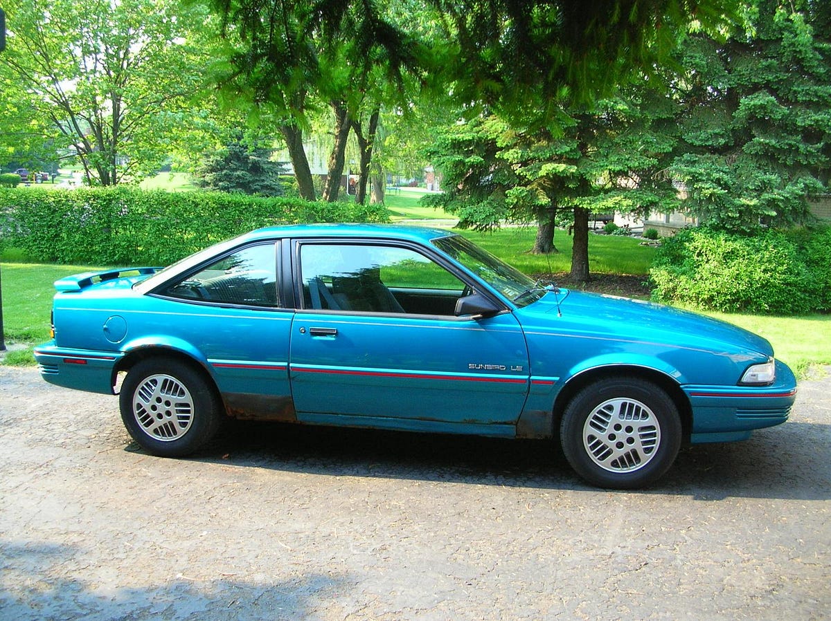 The water close to shore looks like a teal green 1992 Pontiac Sunbird.