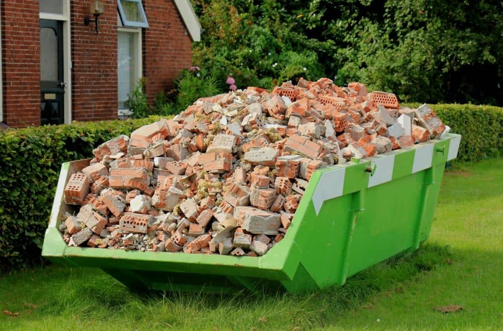 How do you dispose of concrete and brick during construction cleanup