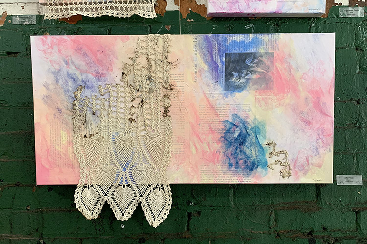 Pink and blue swirling backgrounds cover text depicting Artemisa Gentileschi. A large partially burned piece of antique white crochet covers the pinks and blues on the left.