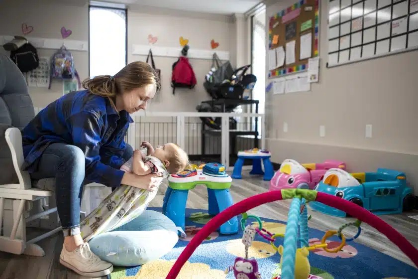 Hailey Eischens picks up Ellery Stulen, 7 months, after a morning