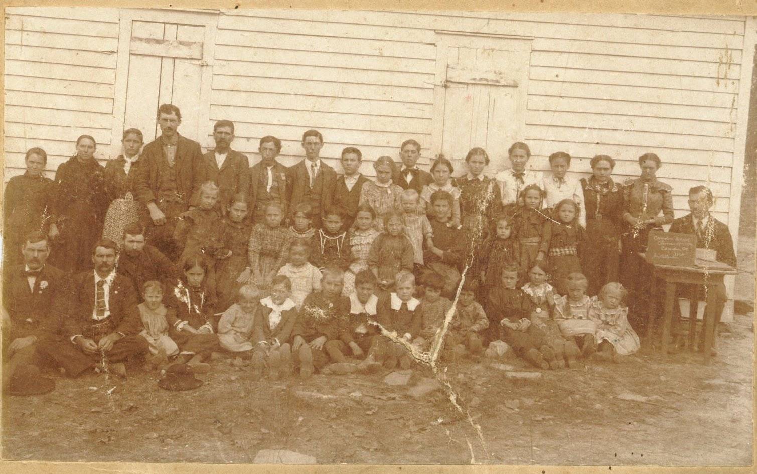 The slate the teacher is holding says