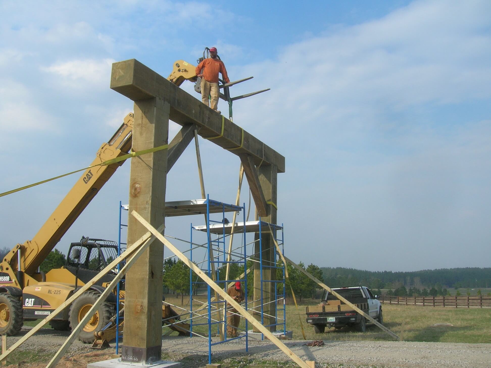 Ranch entrance timber frame gate in Alabama uses massive timbers