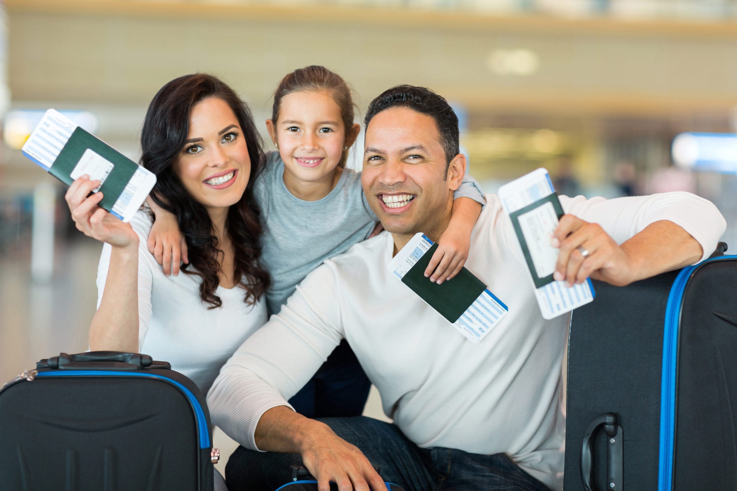 family holding boarding pass and passport » Move Up Travel Solutions