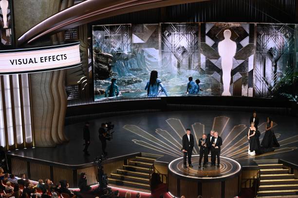US visual effects artist Richard Baneham (C) accepts the Oscar for Best Visual Effects for "Avatar: The Way of Water" onstage during the 95th Annual Academy Awards at the Dolby Theatre in Hollywood, California on March 12, 2023.
Photo Credit: Patrick T. Fallon/AFP via Getty Images