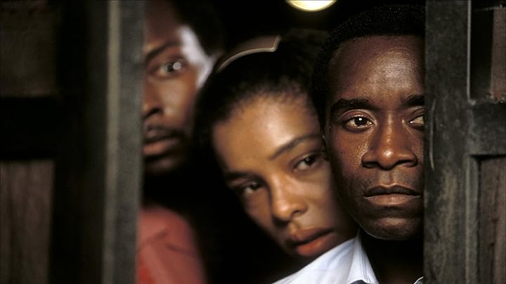 Don Cheadle, Antonio David Lyons, and Sophie Okonedo in "Hotel Rwanda" (2004) Photo Credit: © 2004 United Artists. All rights reserved.