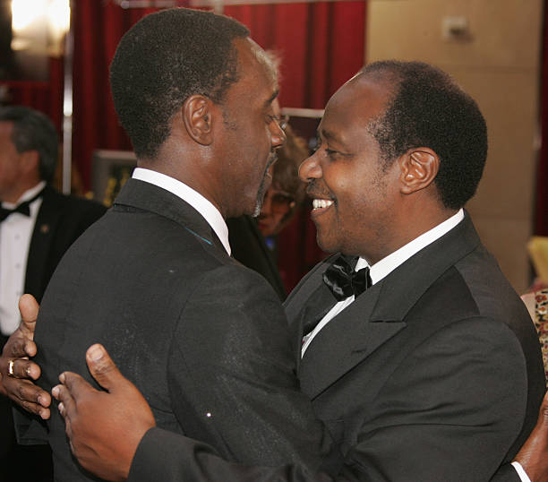 Don Cheadle (L) hugs Paul Rusesabagina at the 77th Annual Academy Awards at the Kodak Theater on February 27, 2005 in Hollywood, California. Cheadle portrayed Rusesabagina in the Oscar nominated film, "Hotel Rwanda." Photo Credit: Vince Bucci/Getty Images