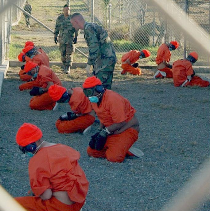 Detainees upon arrival at Camp X-Ray, January 2002 Photo Credit: Wikipedia Commons