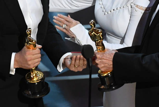 Closeup detail shot of Oscar statuettes as 'La La Land' producer Jordan Horowitz (L) accepts Best Picture after a presentation error (later awarded to 'Moonlight') with actor Warren Beatty onstage during the 89th Annual Academy Awards at Hollywood & Highland Center on February 26, 2017 in Hollywood, California. Photo by Kevin Winter/Getty Images