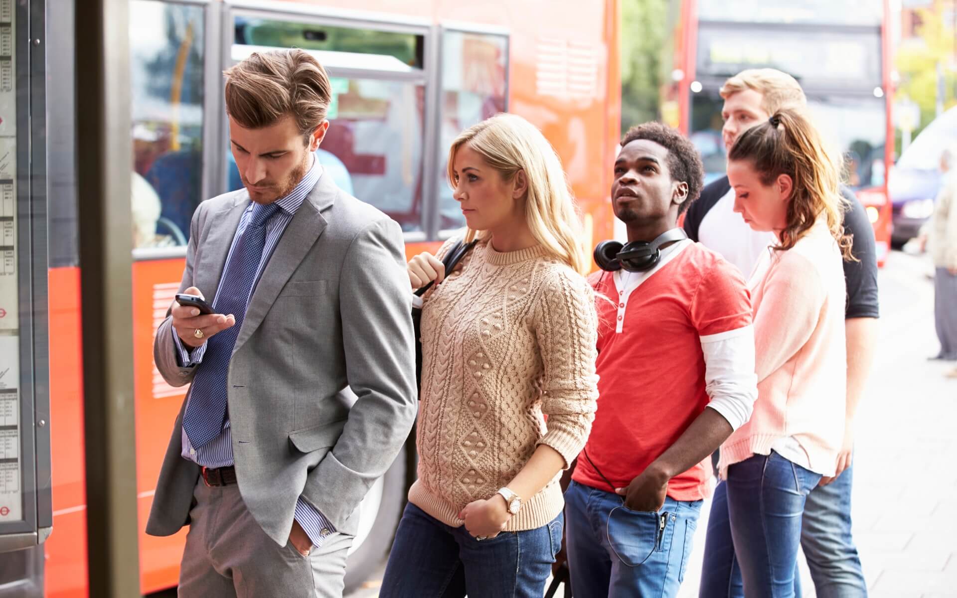 Queue Of People Waiting At Bus Stop mPulse Mobile