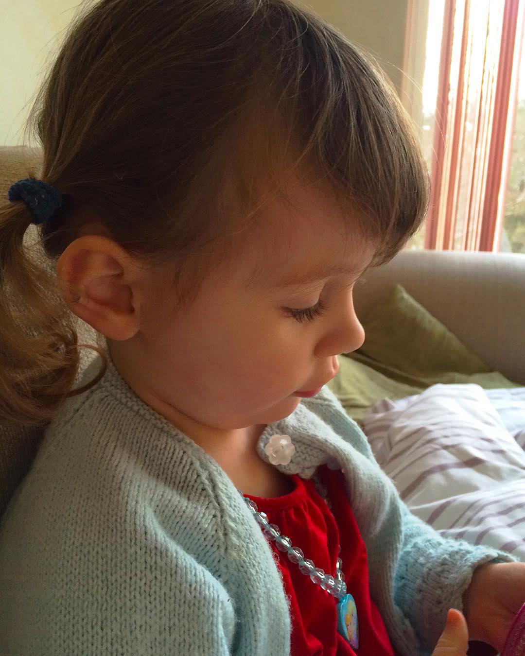 http://mrshsfavouritethings-com.stackstaging.com A beautiful little girl with brown curly hair in bunches and looking down with the face of an angel - 100HappyDays - post one - Mrs H's favourite things