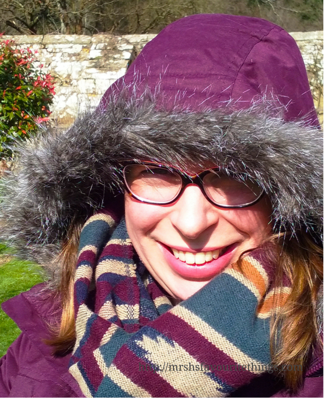 http://mrshsfavouritethings-com.stackstaging.com A facial close up of a young woman standing in the grounds of a stately home, she is wearing a patterned scarf and a purple waterproof coat from Trespass with the faux fur trimmed hood up to protect her from the cold _ Finding the perfect coat with Trespass _ Mrs H's favourite things
