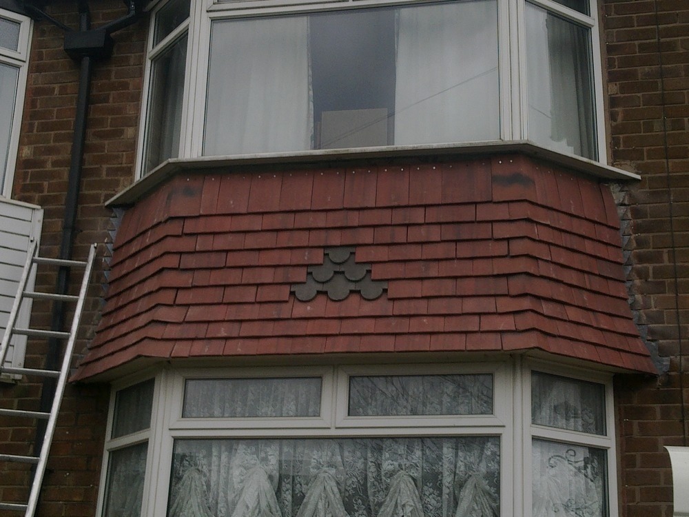 replace render with tiles to the bay window area Roofing job in