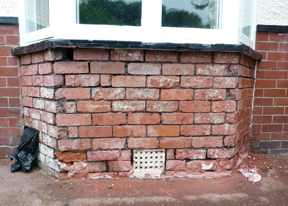 Repointing & brick replacement of wall under bay window Bricklaying