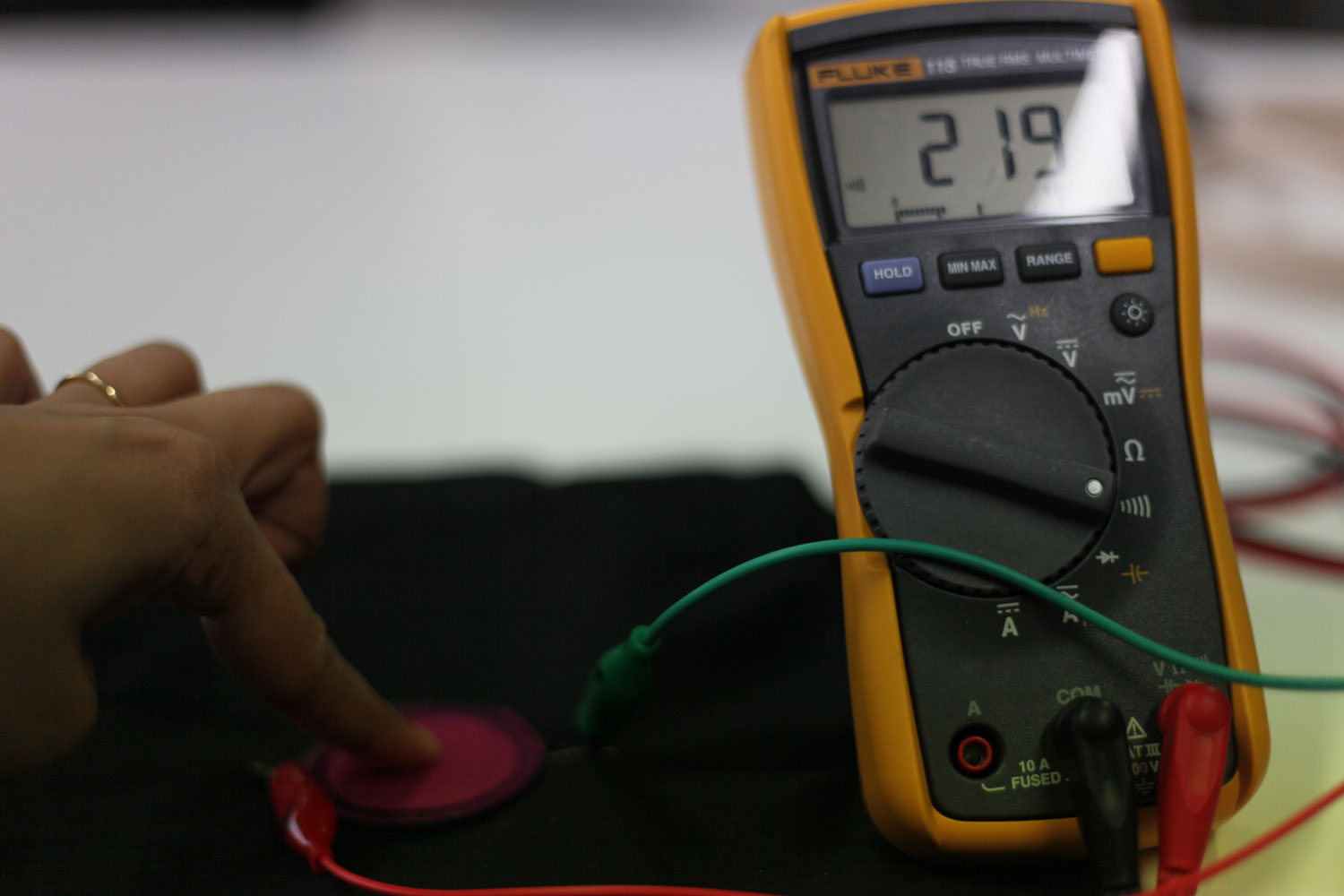 The two conductive parts connect when button is pushed.