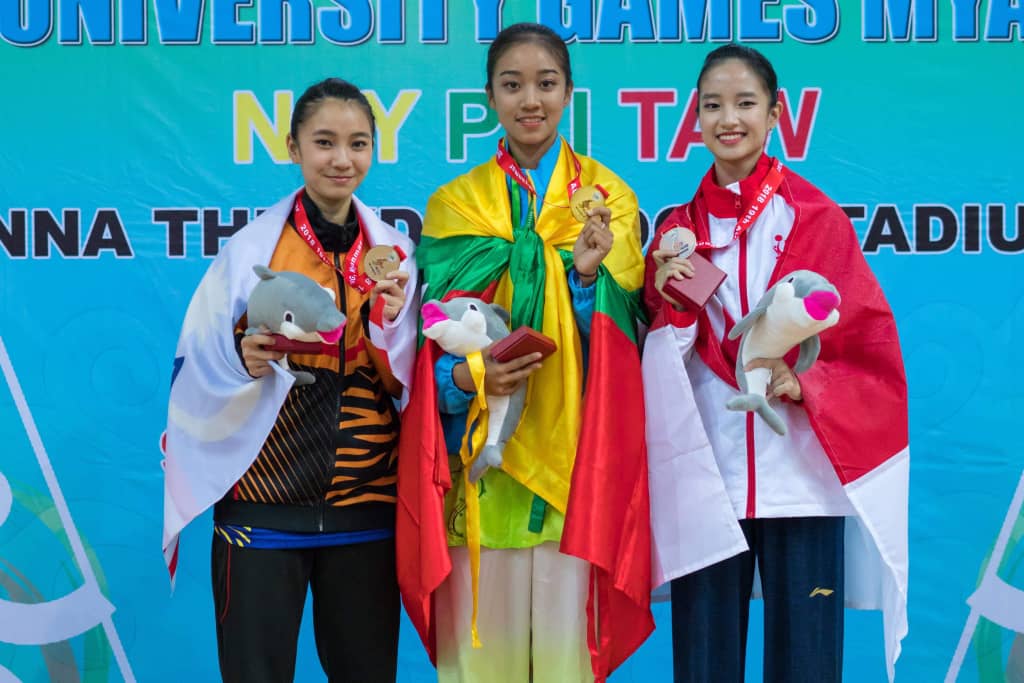 Chan (left) posing with her silver medals and other medal recipients