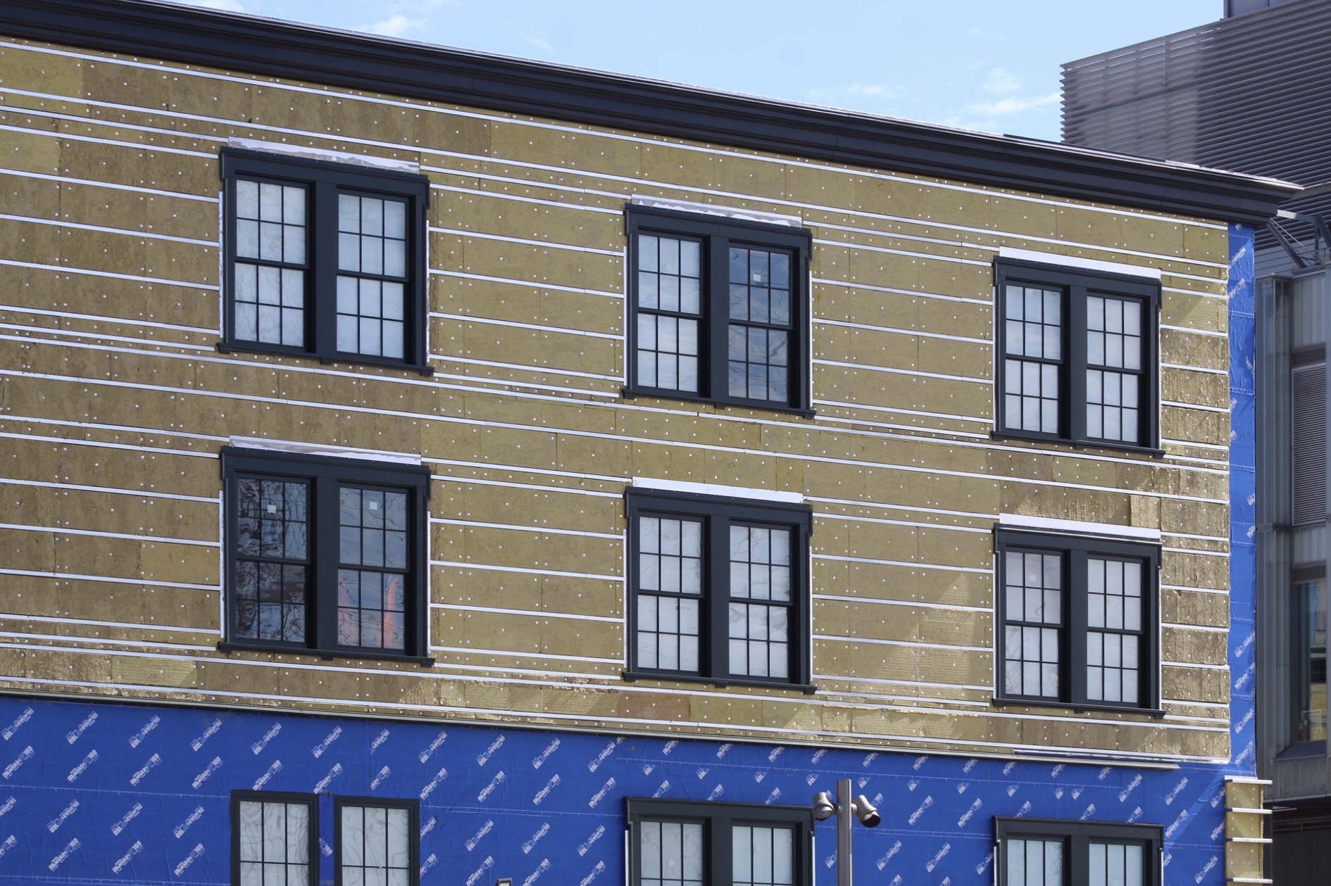 Tin Building's Final Cladding Begins Installation in the Seaport District New York YIMBY