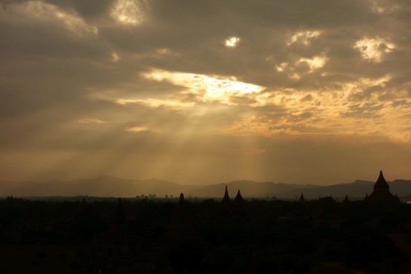 The sun strikes through the clouds at Bagan