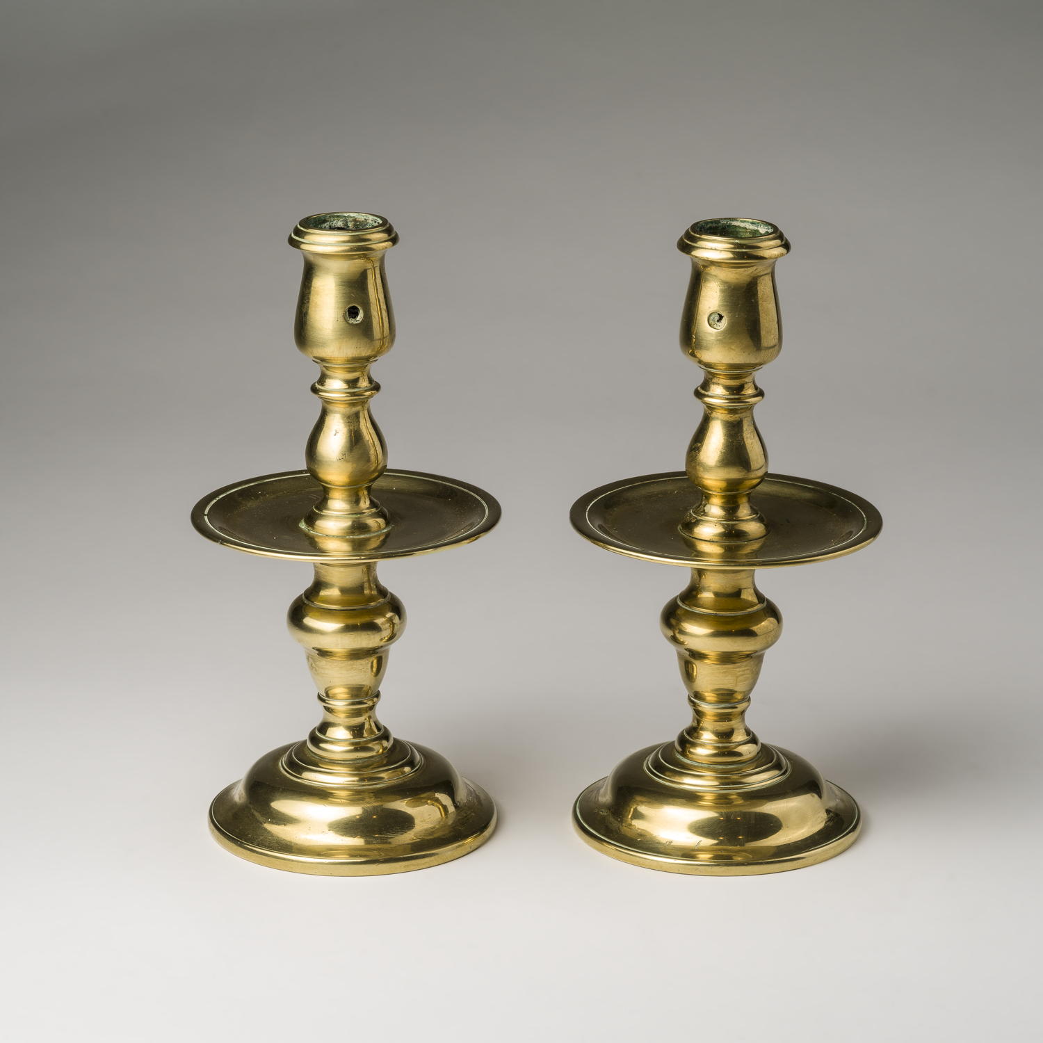 PAIR OF DUTCH BRASS CANDLESTICKS, CENTURY. Northeast Auctions