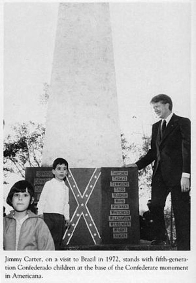 Former US President Jimmy Carter standing in front of a confederate