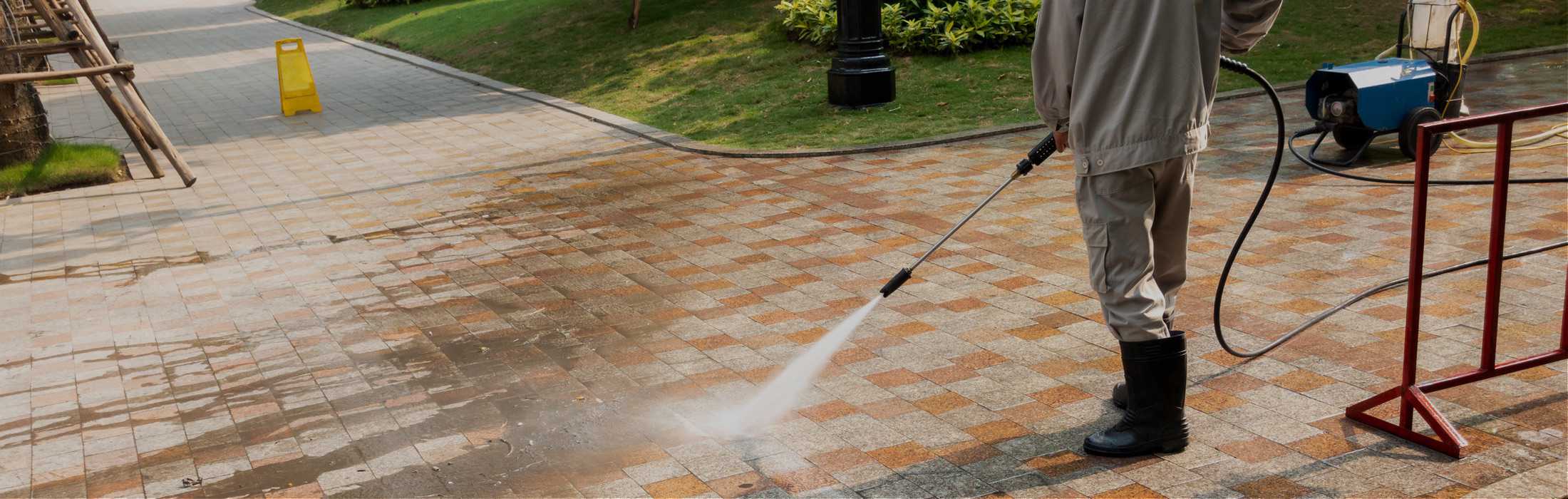 man cleaning terrace with a pressure washer NW Surface Cleaner
