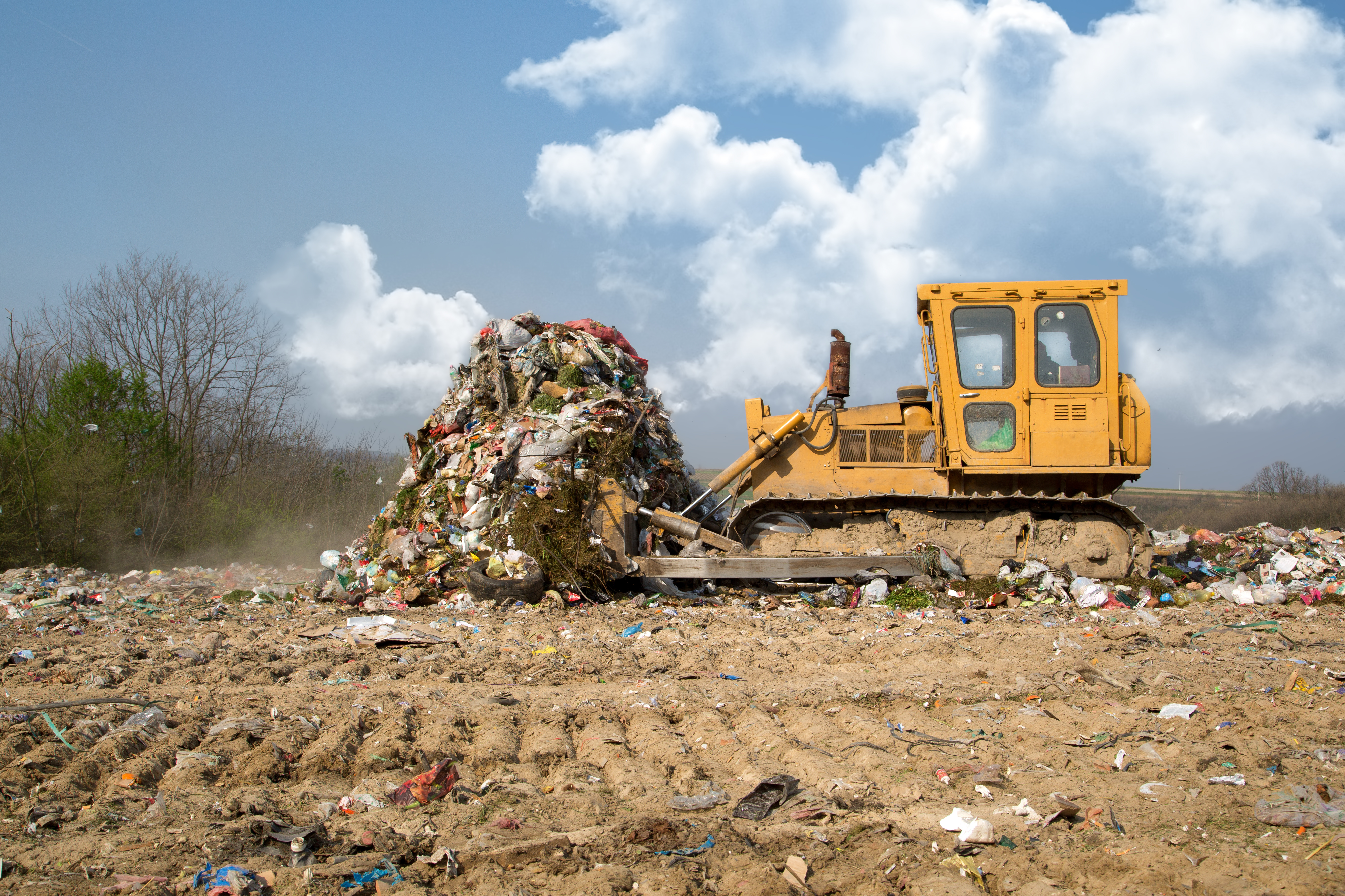The old bulldozer moving garbage in a landfill HDPE Piping Solutions