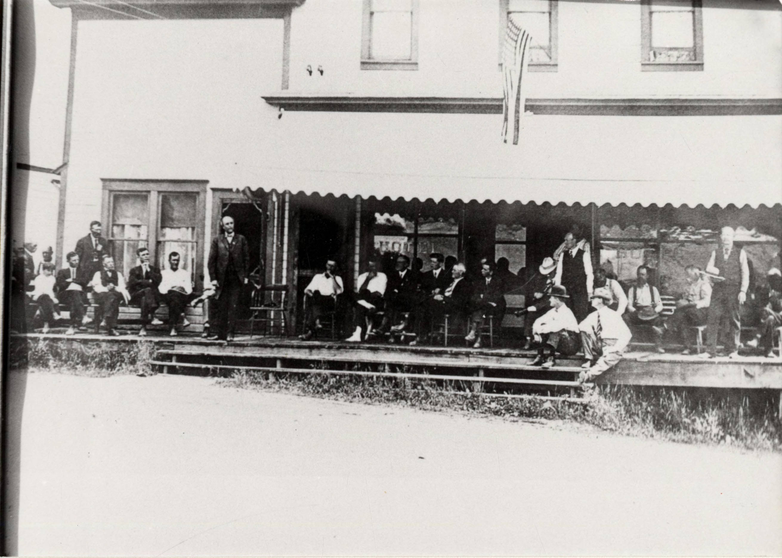 Gathering on the porch of the Carlson Hotel in Deary, Idaho The Trees