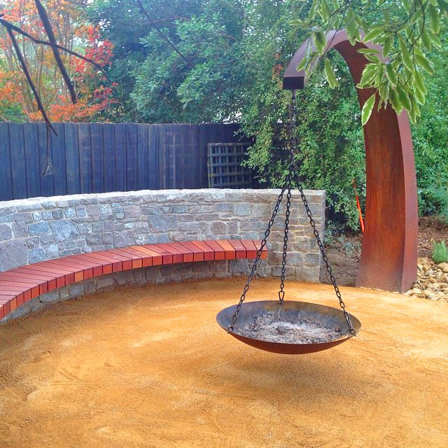 This Hanging Fire Pit Is Held Up With A Giant Arching Metal Beam
