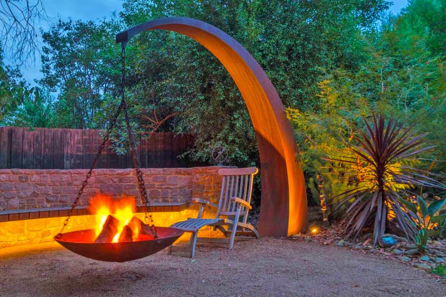 This Hanging Fire Pit Is Held Up With A Giant Arching Metal Beam